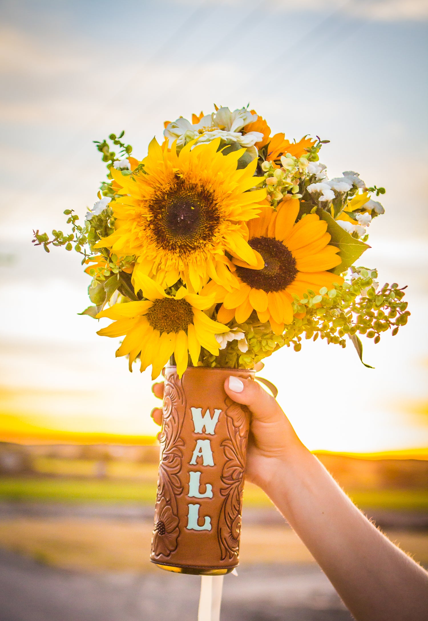 Tooled leather bouquet wrap with sunflowers. Photo credit: Kandee Davis Photography